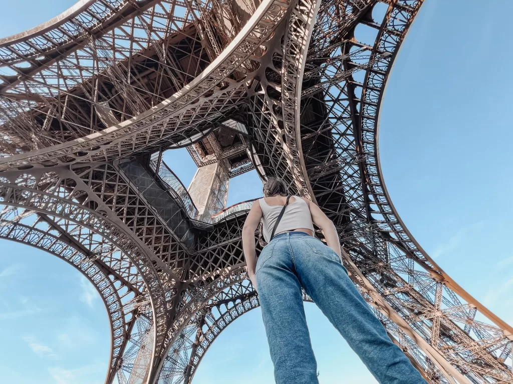 Standing under the eiffel tower and looking up. 