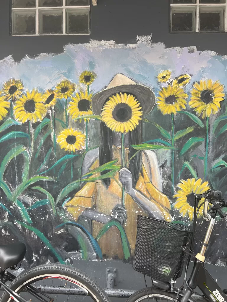 Street art on Arab Street of a girl holding sunflowers
