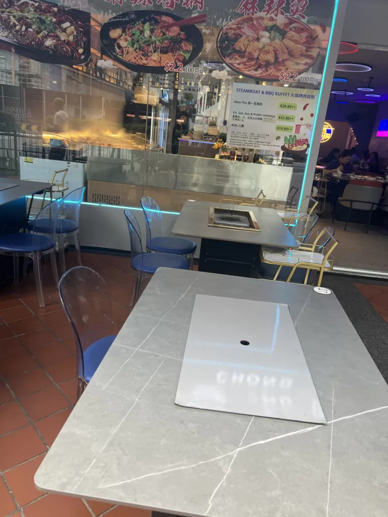 Restaurant table with hot plate in the center for cooking