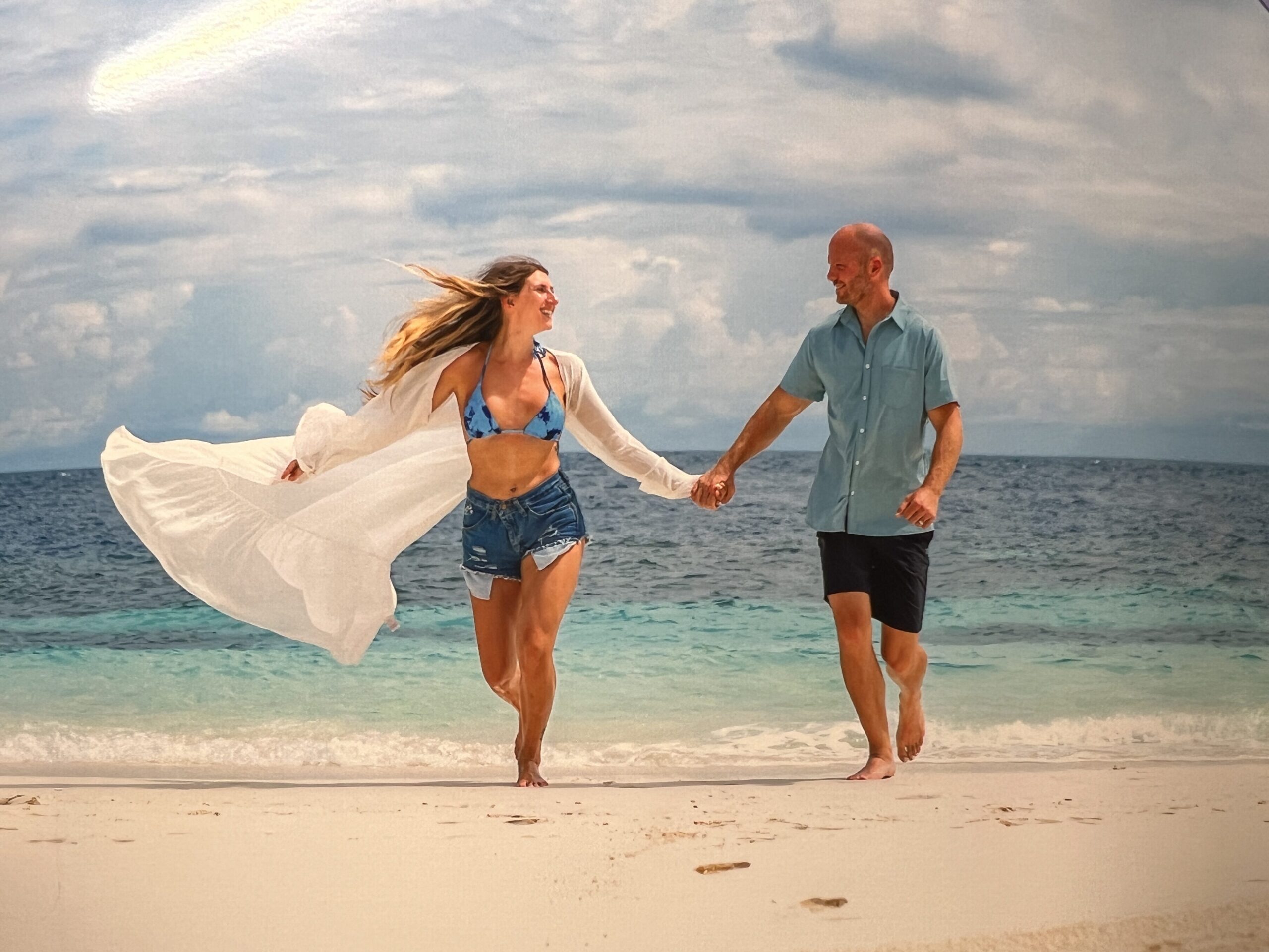 Couple running on the beach at The W Maldives Free photo shoot. 